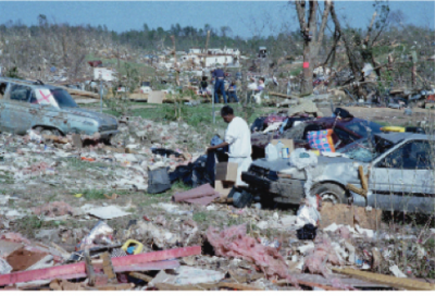person surrounded by tornado wreckage