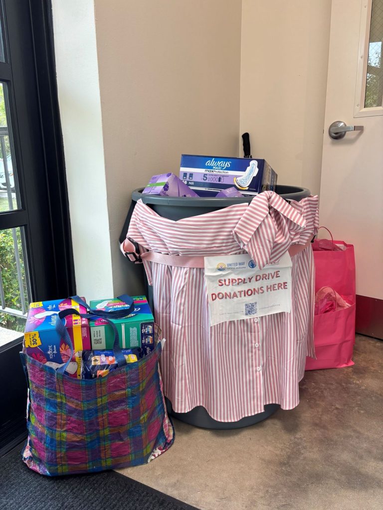 Bags and a collection bin filled with donated period supplies for the United Way supply drive.