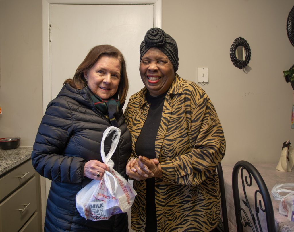 A Meals on Wheels volunteer with a client