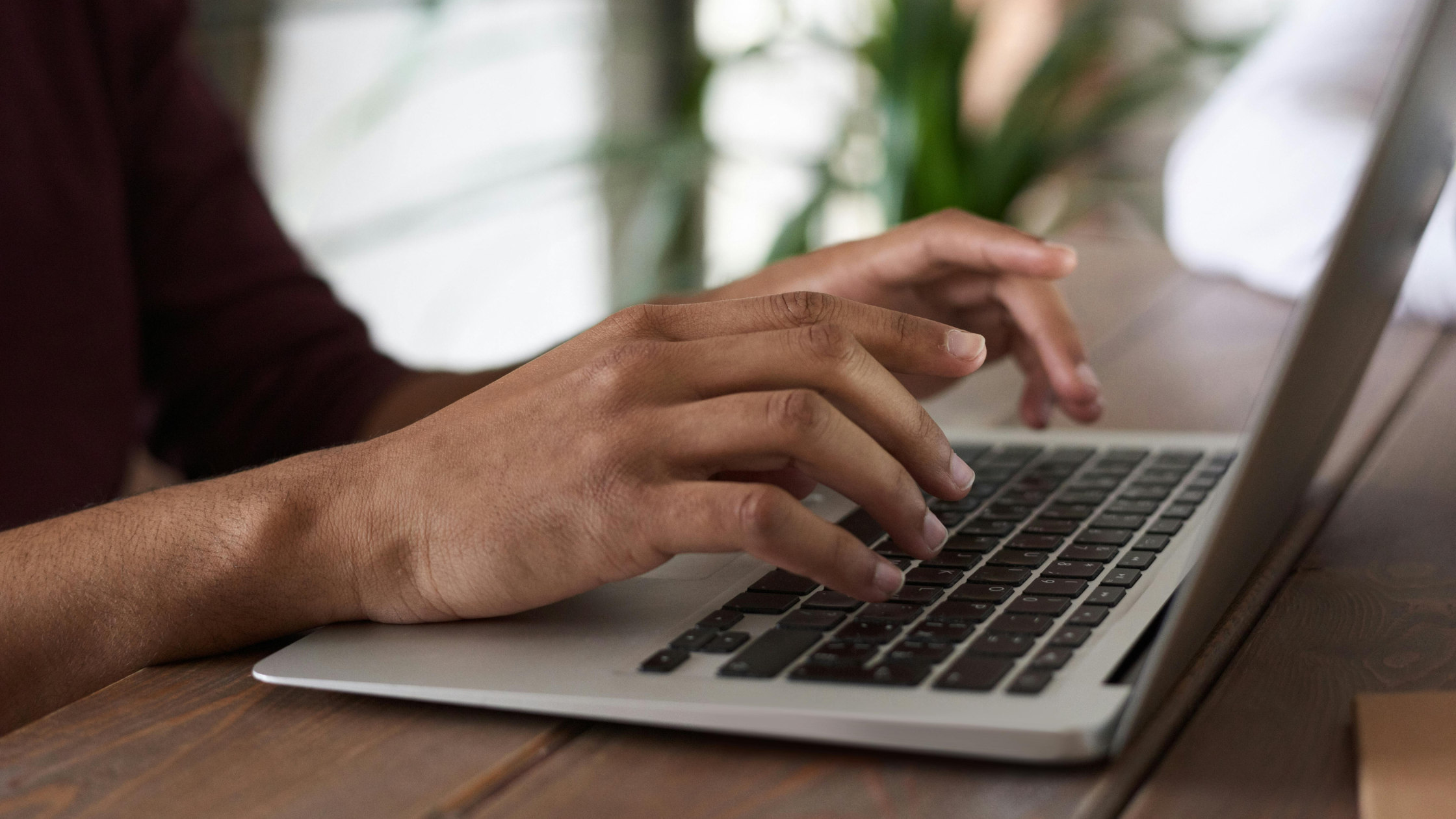 hands typing on keyboard