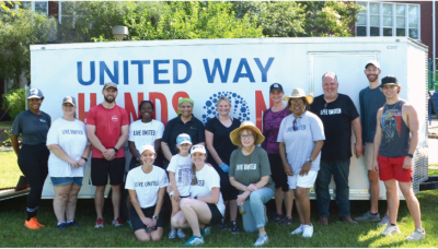 group of volunteers standing in front of United Way Hands On tool trailer