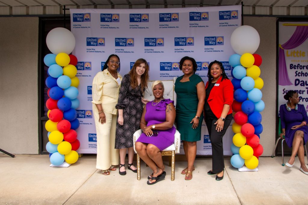 Crystal May, owner of Little Royalties Child Development Center, poses for a photo with UWCA representatives at the Ribbon Cutting for Little Royalities.