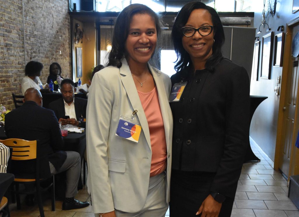 RaSheda Workman smiles with JMDLS Steering Committee member Jasmine Wright.